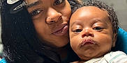 T Ruzin joined the competition — help win amazing prizes! baby, woman, face, portrait, indoor, close_up, person, child, curly_hair, black_hair, clothing, sweatshirt, expression, skin, head, holding, family, love, cute, home