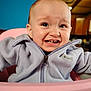 baby, child, fleece_jacket, lavender, pink_high_chair, expression, indoor, kitchen, face, teeth, eyes, person, clothing, zipper, seat, young_child, cute, infant, portrait, warm_clothing