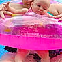 baby, adult, person, swimming_pool, inflatable_ring, water, floating, pink, summer, fun, relaxation, child, parent, swimwear, skin, legs, feet, face, holding, outdoor