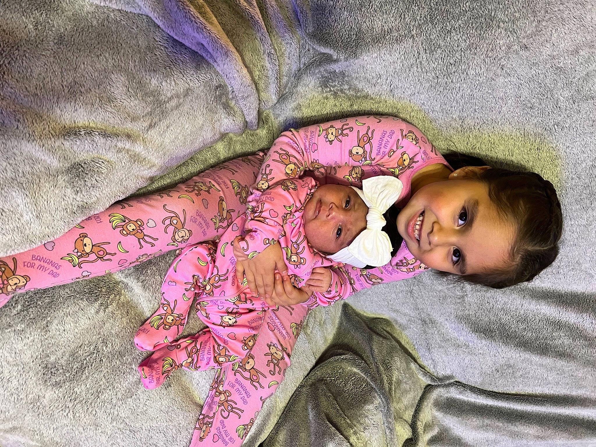 Everleigh is registered to the contest to win money with this photo: baby, baby_products, baby_toddler_clothing, bedding, bedtime, cheek, comfort, eye, happy, head, headwear, joy, linens, magenta, nose, pattern, person, pink, purple, skin