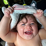 Eugene is registered to the contest to win money with this photo: baby, child, smiling, happy, tooth, blue_eyes, blanket, hood, plush, cute, indoor, portrait, skin, face, hand, fingers, soft, cozy, infant, playful