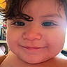 Eugene is registered to the contest to win money with this photo: toddler, child, face, smile, curly_hair, close_up, blue_eyes, skin, cheeks, indoors, person, portrait, baby, expression, happy, head, young_child, warm_lighting, home, candid