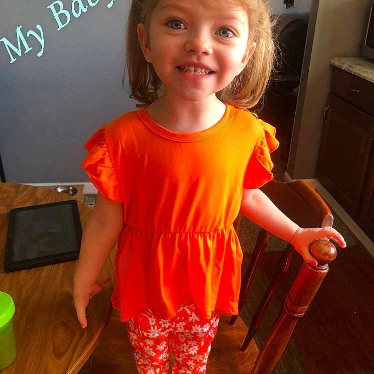 Miriam joined the competition — help win amazing prizes! architecture, building, child, clothing, diningroom, diningtable, face, female, furniture, girl, head, indoors, person, photography, portrait, room, shorts, t_shirt, table, wood