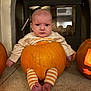 Autumn joined the competition — help win amazing prizes! baby, pumpkin, halloween, costume, cute, child, indoors, fireplace, carved_pumpkin, striped_leggings, orange, floor, expression, sitting, holiday, festive, autumn, face, portrait, seasonal