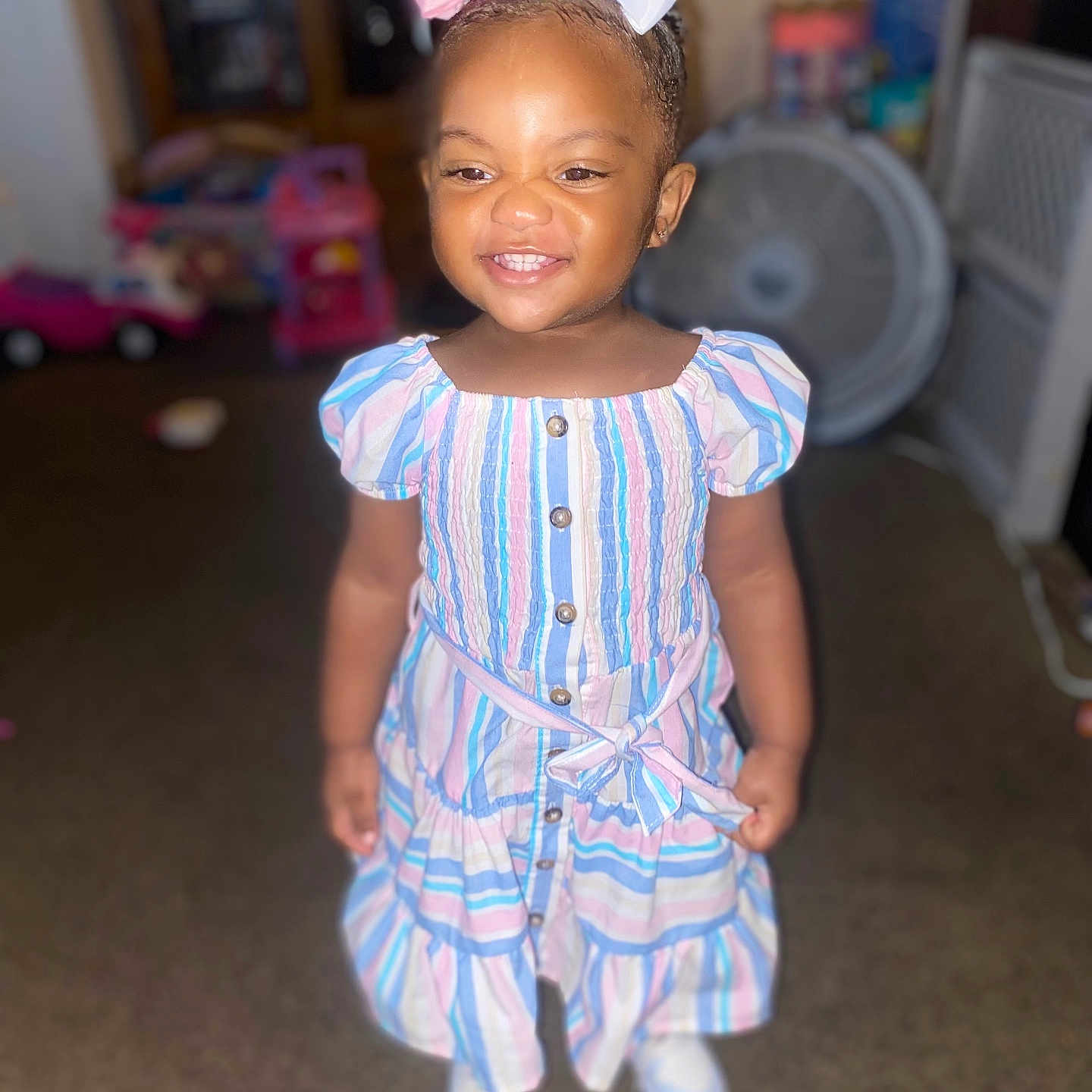 Nalani is registered to the contest to win money with this photo: car, child, clothing, dress, face, female, footwear, girl, happy, head, indoors, machine, pants, person, photography, portrait, shoe, smile, transportation, wheel