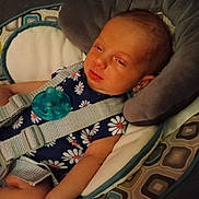 Annabelle joined the competition — help win amazing prizes! baby, infant, child, pacifier, baby_seat, seatbelt, clothing, pattern, daisy, cushion, fabric, person, face, arm, headrest, indoors, resting, cute, sleepy, comfort