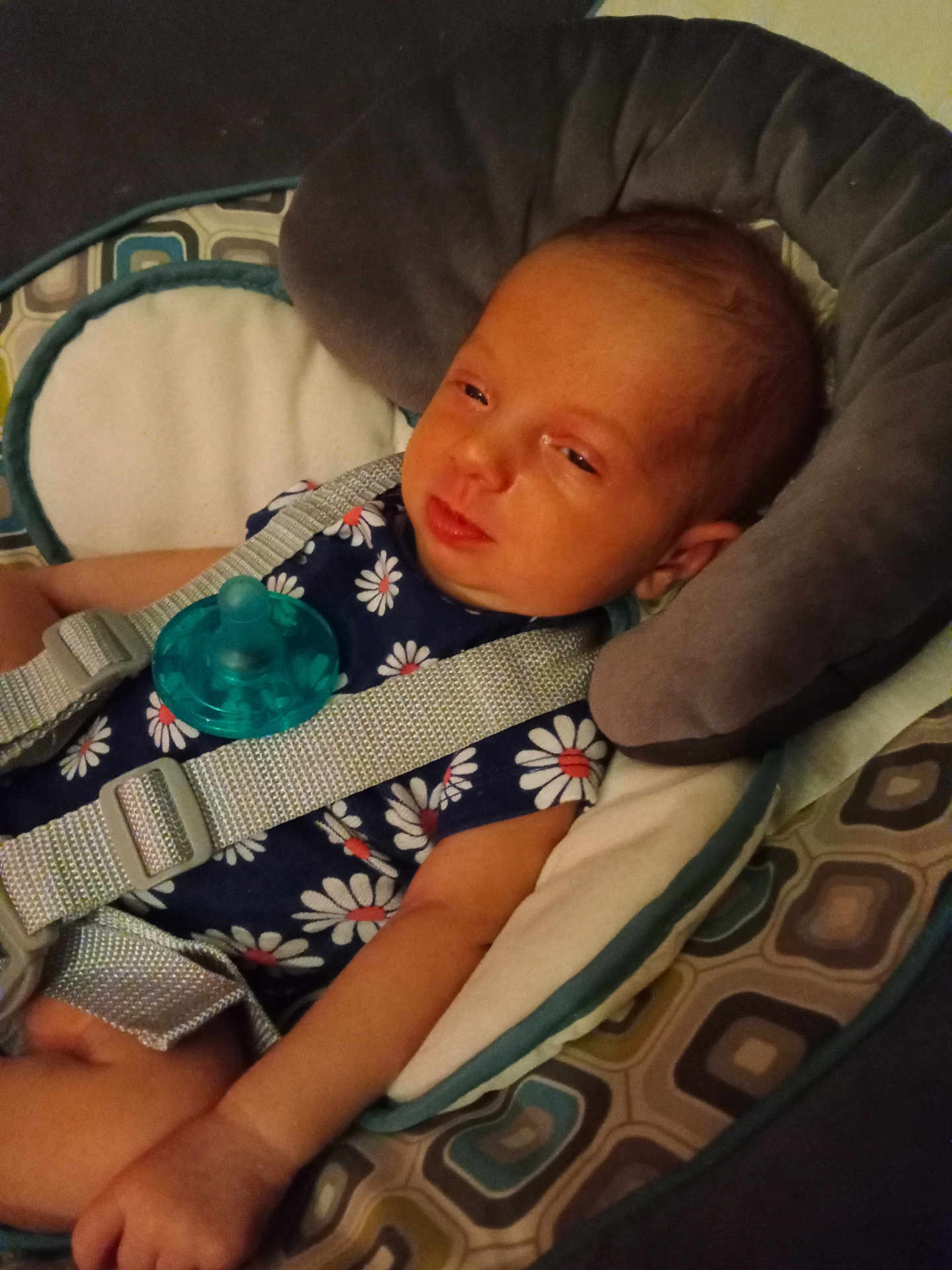 Annabelle joined the competition — help win amazing prizes! baby, infant, child, pacifier, baby_seat, seatbelt, clothing, pattern, daisy, cushion, fabric, person, face, arm, headrest, indoors, resting, cute, sleepy, comfort