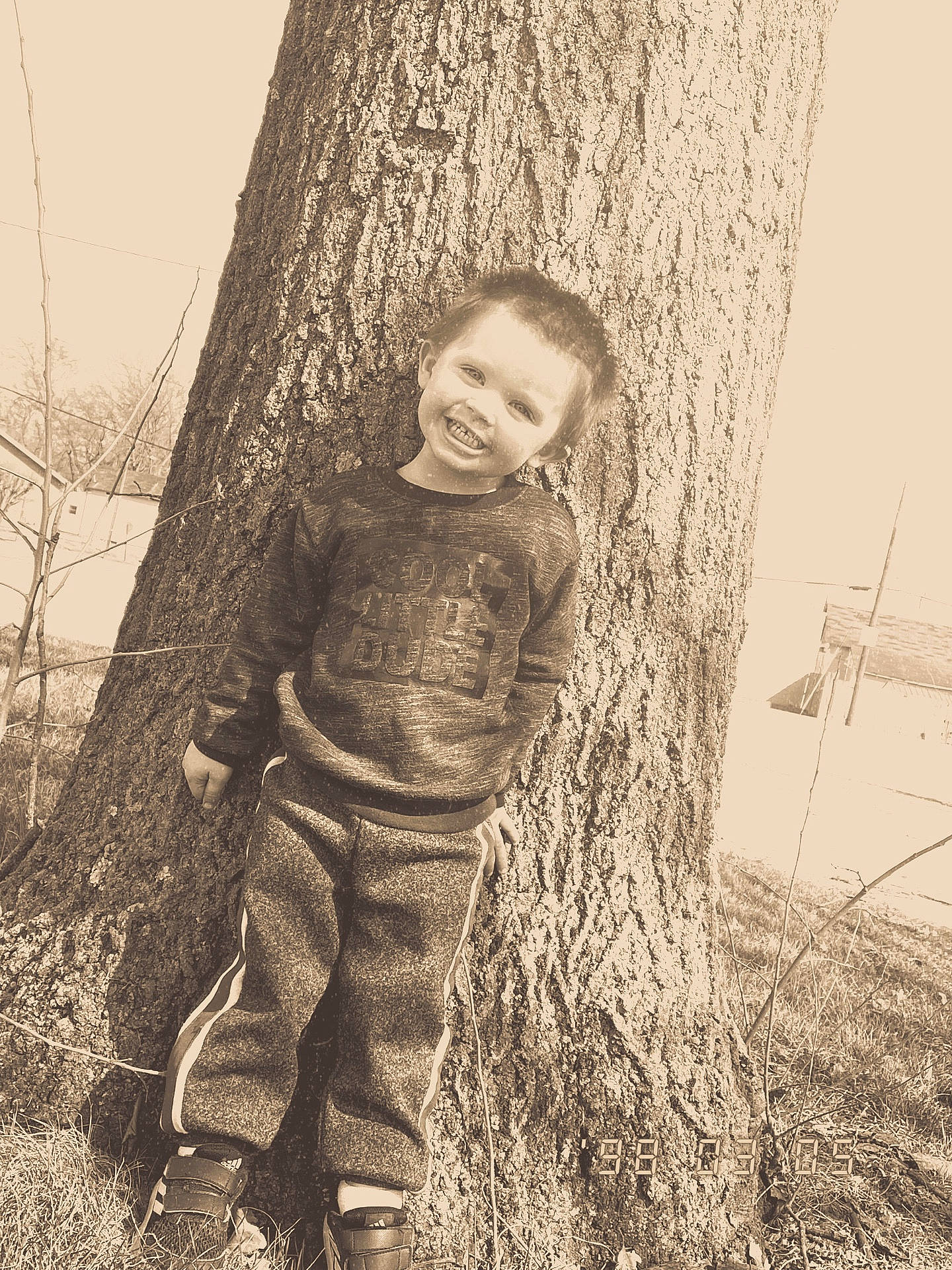 Wiatt is registered to the contest to win money with this photo: child, fun, gesture, grass, happy, human_body, joy, monochrome, monochrome_photography, people_in_nature, person, plant, sitting, smile, stock_photography, toddler, tree, trunk, twig, vintage_clothing