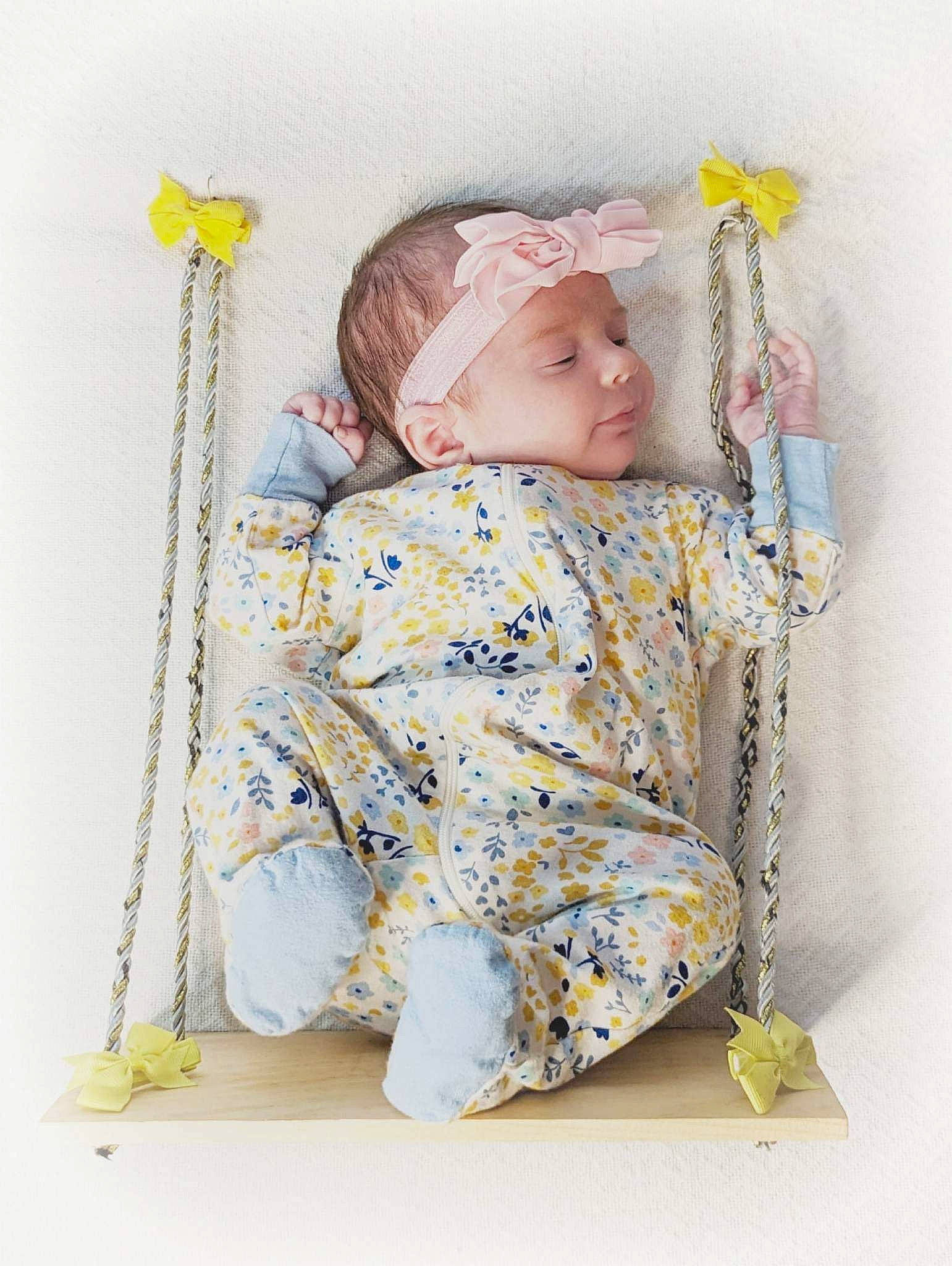 Novah is registered to the contest to win money with this photo: baby, baby_products, baby_safety, baby_sleeping, baby_toddler_clothing, chair, child, comfort, fashion_accessory, happy, headwear, linens, pattern, person, portrait_photography, room, sitting, sleeve, textile, toddler