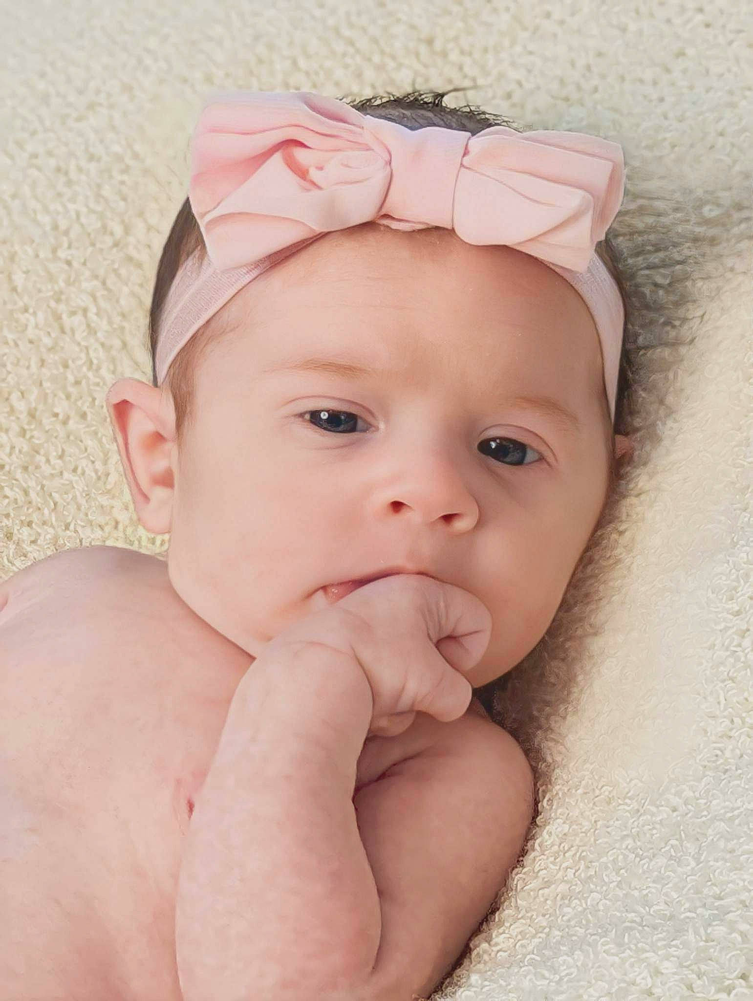 Novah is registered to the contest to win money with this photo: baby, baby_toddler_clothing, cheek, ear, eye, eyelash, face, finger, gesture, happy, headband, headgear, headpiece, headwear, iris, lip, neck, nose, person, skin