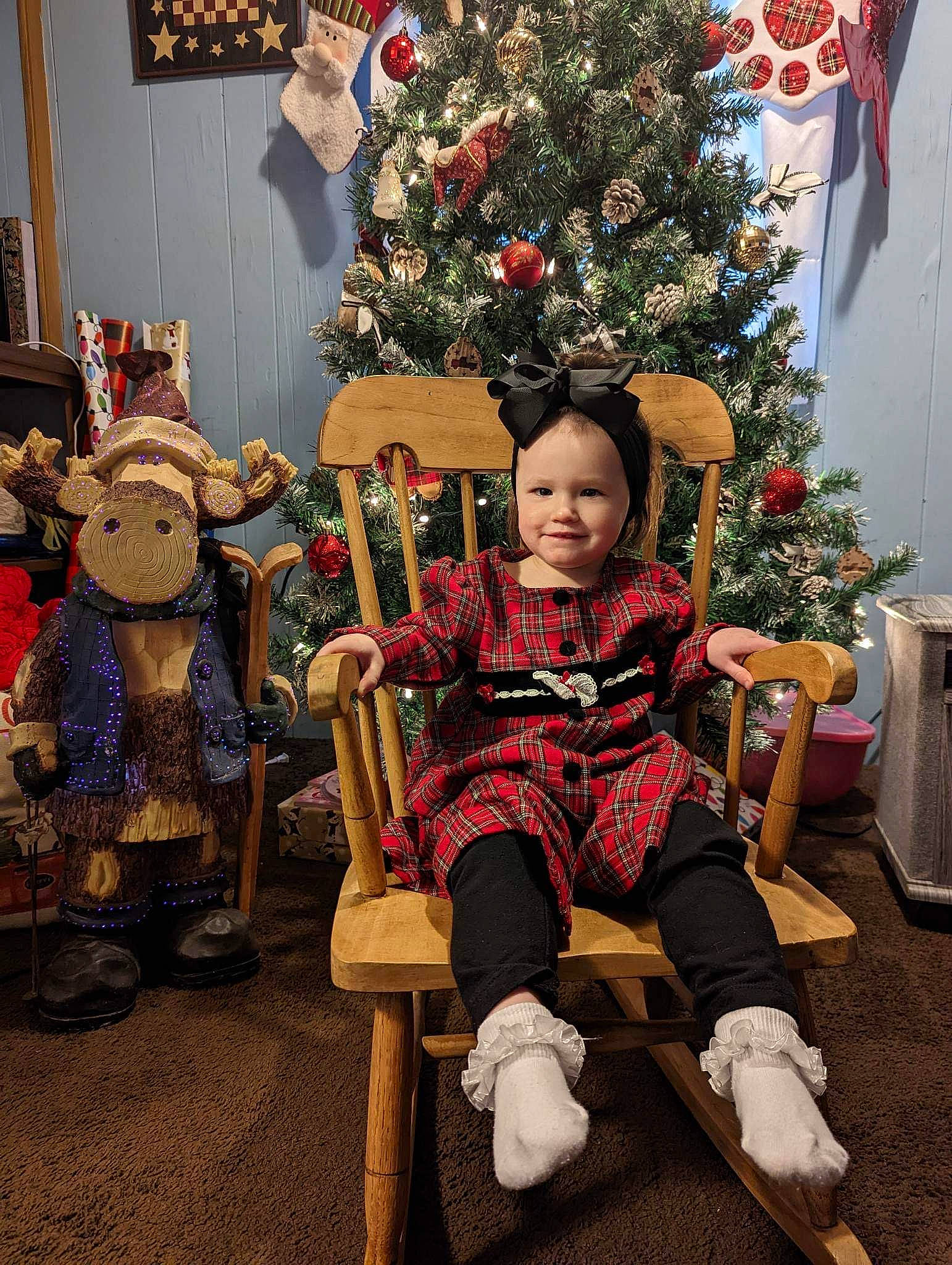 Nylah joined the competition — help win amazing prizes! chair, christmas_decoration, christmas_ornament, christmas_tree, event, fun, happy, head, holiday, human_body, joy, lap, leisure, ornament, person, plant, standing, toddler, tradition, tree