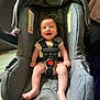 Ella is registered to the contest to win money with this photo: baby, car, car_interior, carseat, clothing, coat, cushion, face, furniture, happy, head, homedecor, jacket, pants, person, photography, portrait, stroller, transportation, vehicle