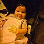 Adeline joined the competition — help win amazing prizes! baby, infant, smile, blanket, stroller, mesh, child, cute, portrait, clothing, hand, face, happy, seated, young, indoors, warm_lighting, comfort, head, person
