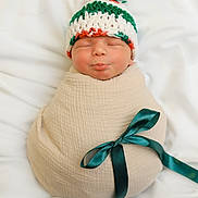 Benjamin joined the competition — help win amazing prizes! newborn, baby, sleeping, wrapped, blanket, ribbon, knitted_hat, pom_pom, green, white, red, soft, cute, infant, portrait, cozy, resting, child, peaceful, indoors