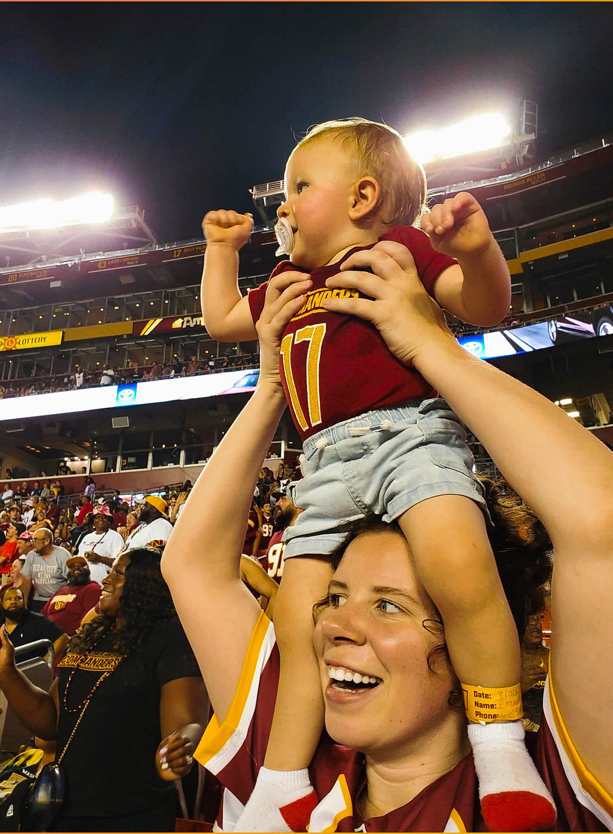 Brantley is registered to the contest to win money with this photo: arena, championship, competition_event, crowd, entertainment, event, fan, gesture, happy, headwear, human_leg, joy, person, player, shorts, smile, sports, sports_uniform, sportswear, team