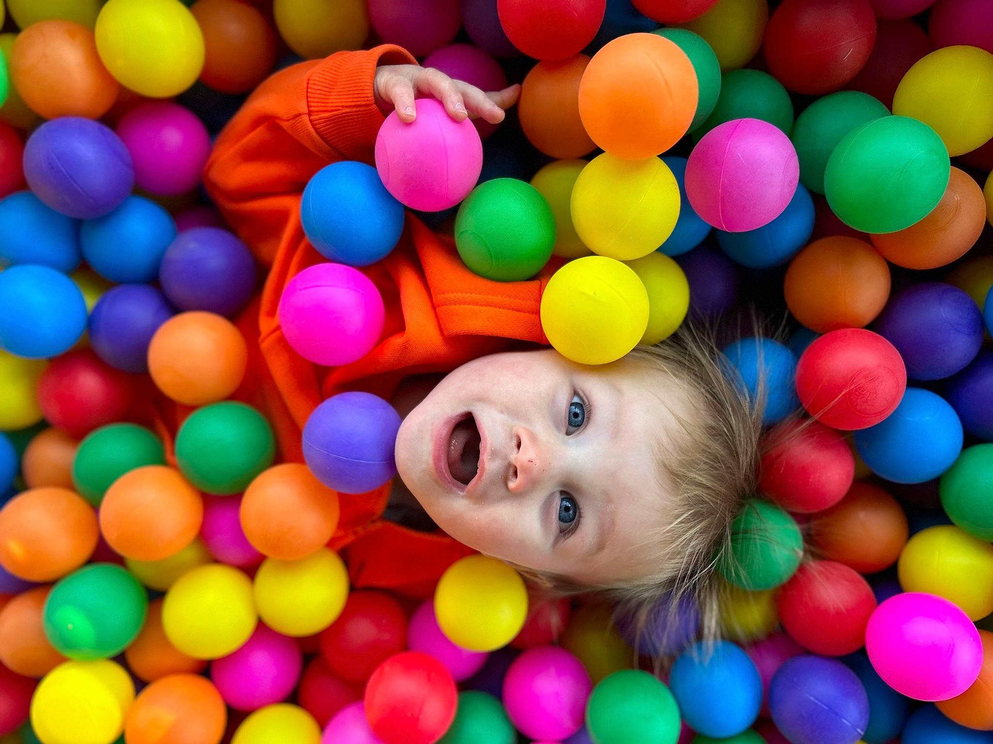 Brantley is registered to the contest to win money with this photo: art, baby, baby_toys, ball_pit, child, circle, colorfulness, facial_expression, fun, happy, leisure, mixture, organ, people, person, play, product, smile, surprise, toddler