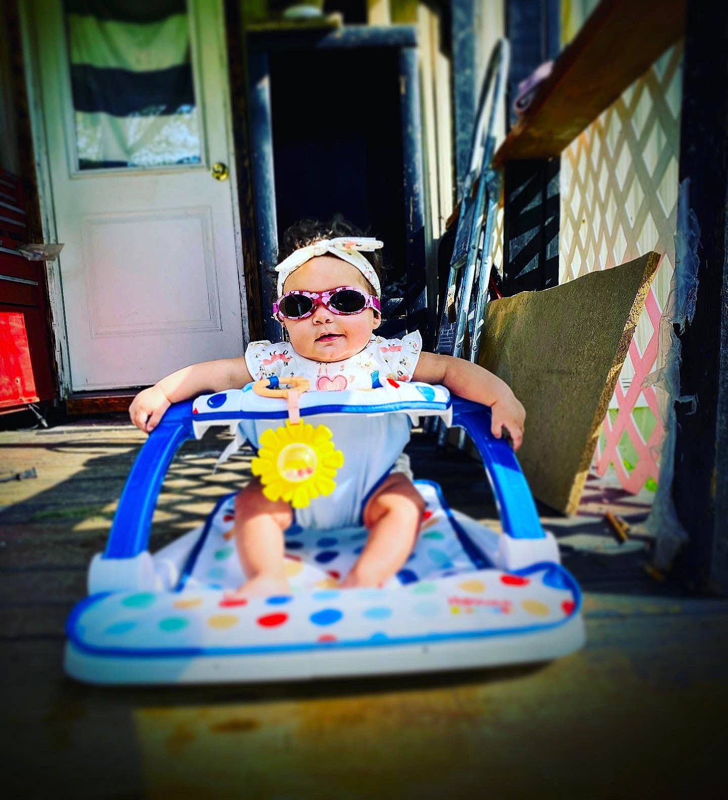Cadence is registered to the contest to win money with this photo: baby_products, baby_toys, child, cool, electric_blue, eyewear, flooring, fun, glasses, goggles, leisure, person, personal_protective_equipment, plastic, recreation, room, sitting, sunglasses, toddler, toy