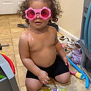 Reign joined the competition — help win amazing prizes! toddler, child, pink_sunglasses, curly_hair, book, tile_floor, indoor, shoes, toy, kneeling, black_shorts, playtime, cute, young_child, home, colorful, floor, reading, fun, casual