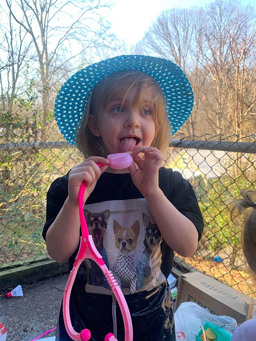 Evelynn joined the competition — help win amazing prizes! blue, child, costume_hat, fashion_accessory, fence, fun, grass, happy, hat, leisure, magenta, people_in_nature, person, pink, plant, recreation, sky, sombrero, sun_hat, toddler