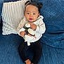 Madison a rejoint le concours — aidez-le/la à gagner de superbes lots ! baby, child, plush_toy, penguin, couch, blue_couch, pillow, white_pillow, black_pants, hoodie, indoor, barefoot, cute, smiling, portrait, seated, cozy, hair_buns, infant, happy