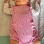 baby, infant, pink_clothing, romper, socks, blanket, fabric, soft_texture, lying_down, cute, newborn, skin, face, head, arms, legs, cozy, indoor, child, toddler