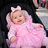 baby, child, pink_dress, headband, stroller, smiling, outdoor, happy, portrait, cute, infant, tulle, clothing, person, face, seat, people, daylight, fashion, accessory