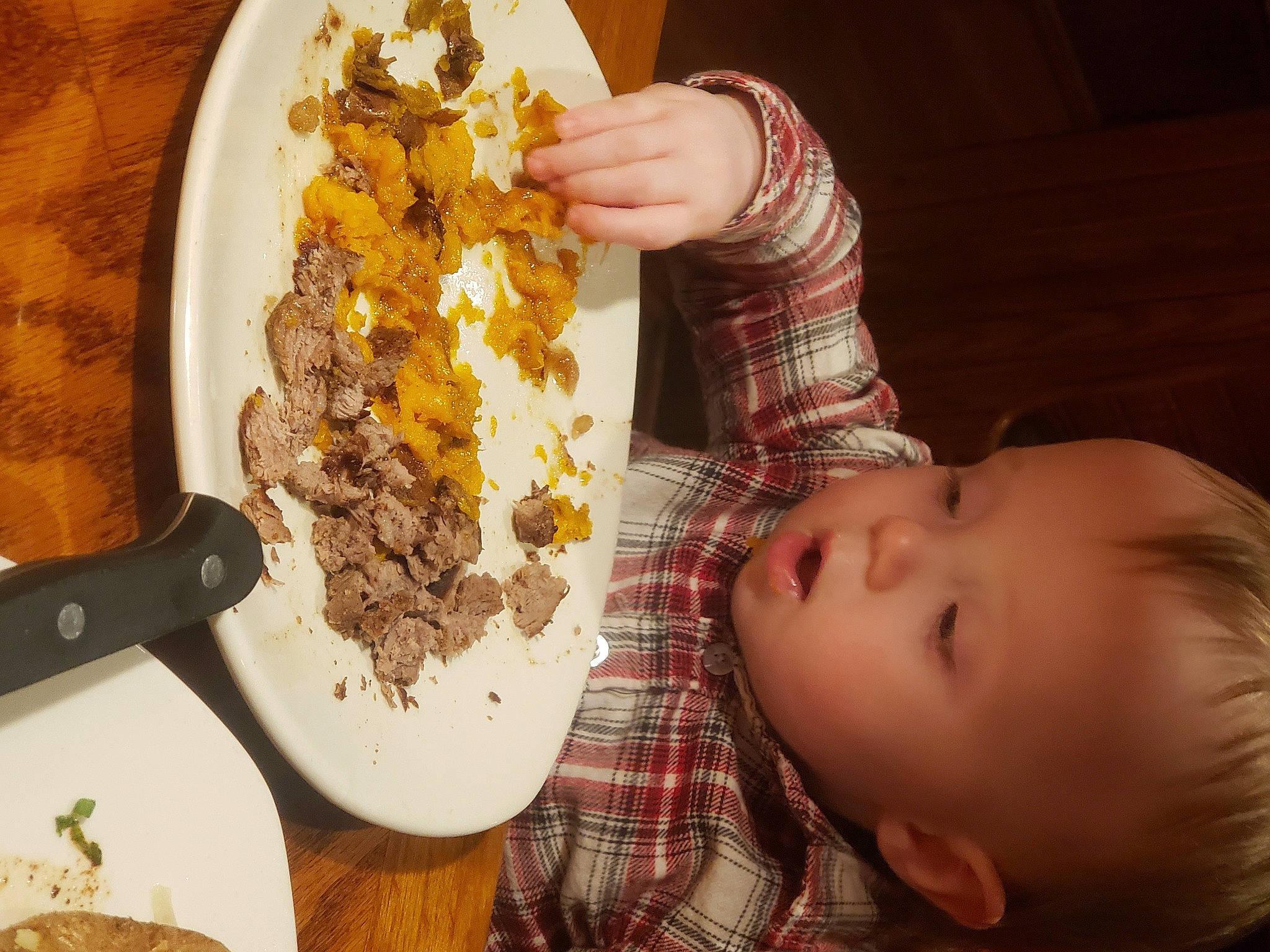 Daniel is registered to the contest to win money with this photo: baby, comfort_food, cuisine, dairy, dish, dishware, food, food_craving, fork, grape, ingredient, kitchen_utensil, person, plate, recipe, scrambled_eggs, staple_food, tableware, tartan, toddler