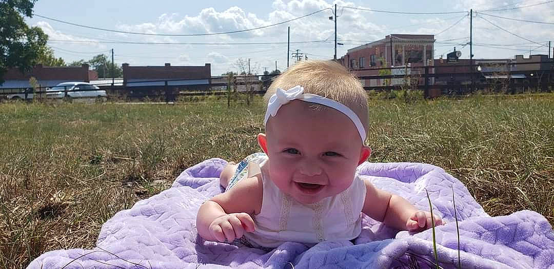 Raven joined the competition — help win amazing prizes! baby, child, face, facial_expression, fun, grass, happy, head, headgear, headwear, joy, people, person, play, sitting, skin, smile, summer, toddler, vacation