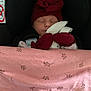 baby, sleeping, car_seat, red_hat, bow, blanket, pink_blanket, plush_toy, bunny_toy, child, infant, cozy, cute, peaceful, face, headwear, soft_toy, resting, indoors, safe