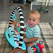 Beau joined the competition — help win amazing prizes! toddler, child, toy, piano, rings, rug, floor, indoor, playtime, cute, baby, striped_shirt, plastic_toys, colorful, home, furniture, flooring, pet_bowl, bag, slippers