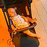 baby, stroller, sleeping, child, overalls, footwear, toddler, outdoor, sidewalk, tile_floor, sunlight, peaceful, cute, infant, seat, resting, baby_clothes, legs, hand, daytime