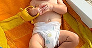 Beau joined the competition — help win amazing prizes! baby, towel, toy, diaper, beach, sand, sunlight, smile, barefoot, orange, yellow, infant, relaxing, child, outdoor, cute, skin, playful, summer, lying_down