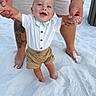 baby, child, smiling, holding_hands, tattoo, sand, beach, shorts, shirt, barefoot, adult, legs, watch, happy, outdoor, summer, sunny, cute, portrait, person