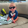 Beau joined the competition — help win amazing prizes! baby, sunglasses, boat, water, towel, seat, mohawk, child, outdoor, river, nature, greenery, blue, clothing, cute, summer, sunny, portrait, sitting, adventure