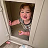 Terrence is registered to the contest to win money with this photo: baby, child, clothing, cubbyhole, curly_hair, cute, door, face, floor, hand, happy, indoor, nursing_pillow, playful, skin, small_door, smiling, toddler, toy, wood