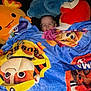Ryder is registered to the contest to win money with this photo: bedtime, blanket, child, colorful, comfort, covered, cozy, cute, fun, giraffe, happy, indoor, person, plush_toys, portrait, red_character, smiling, soft, toy, turtle