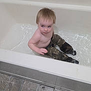 Ryder joined the competition — help win amazing prizes! bathroom, bathtub, camo_pants, candid, casual, child, curious_expression, floor_tiles, home, indoor, person, plumbing, real_photo, short_hair, sitting, skin, toddler, water, wet_clothing, young_child