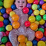 Aurora joined the competition — help win amazing prizes! baby, ball_pit, bright_colors, child, colorful_balls, face, feet, hands, happy, head, indoor, infant, onesie, pillow, plastic_balls, playing, portrait, smiling, surprised, toy