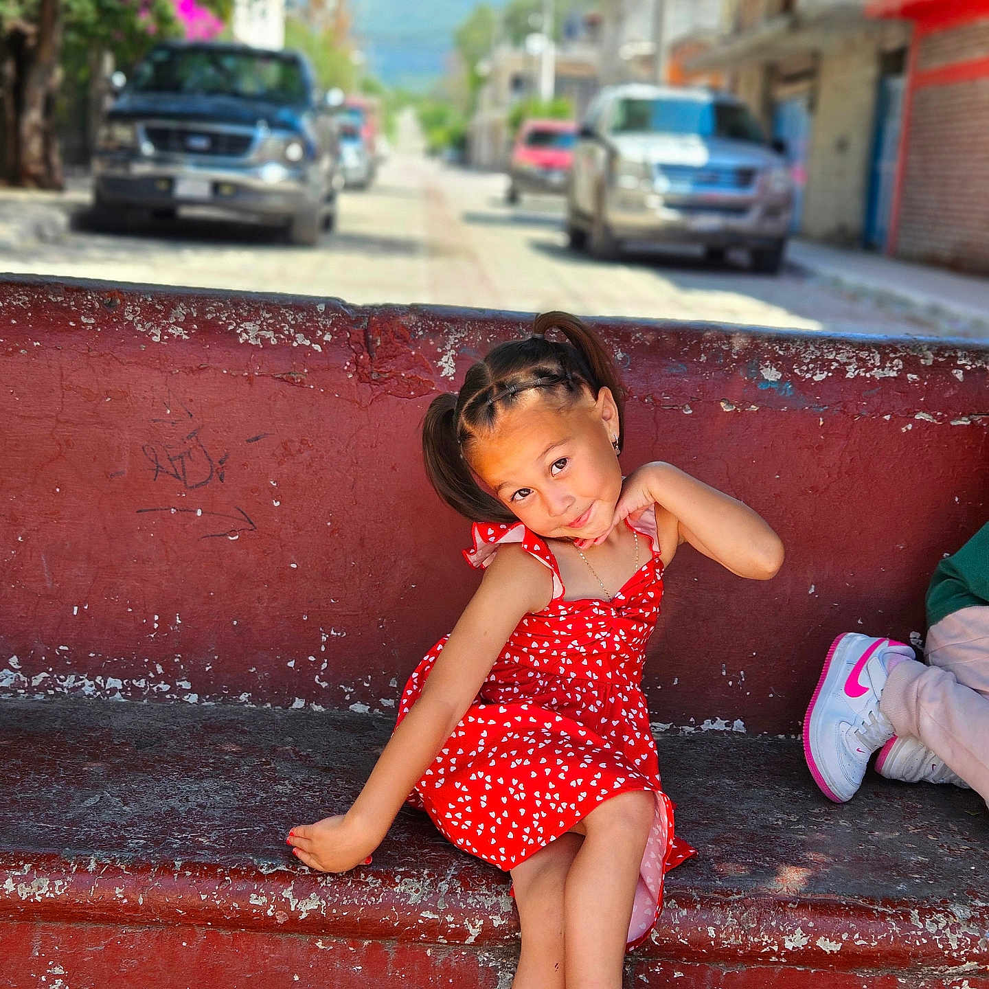 Natalie is registered to the contest to win money with this photo: child, city, clothing, dress, face, female, footwear, girl, head, licenseplate, person, photography, portrait, road, sandal, shoe, sitting, street, transportation, urban