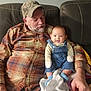 Brentley joined the competition — help win amazing prizes! arm, baby, beard, blanket, cap, casual_clothing, couch, cozy, denim_overalls, family, hand, indoor, infant, man, plaid_shirt, portrait, seated, smile, socks, sofa