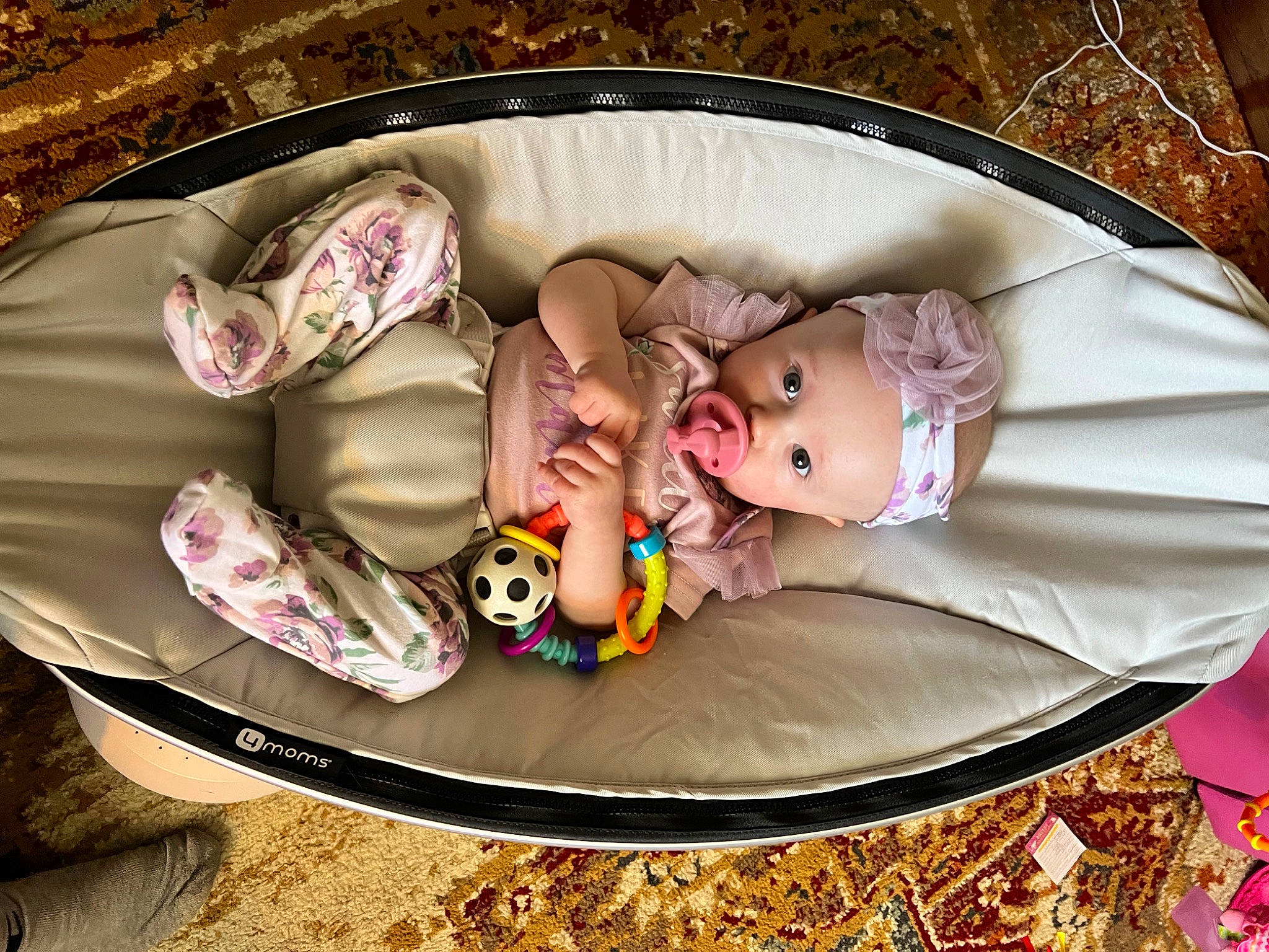 Ruby is registered to the contest to win money with this photo: baby, baby_carriage, baby_products, baby_toddler_clothing, bag, child, circle, comfort, fashion_accessory, grass, infant_bed, linens, luggage_and_bags, mammal, pattern, person, pink, product, sitting, toddler
