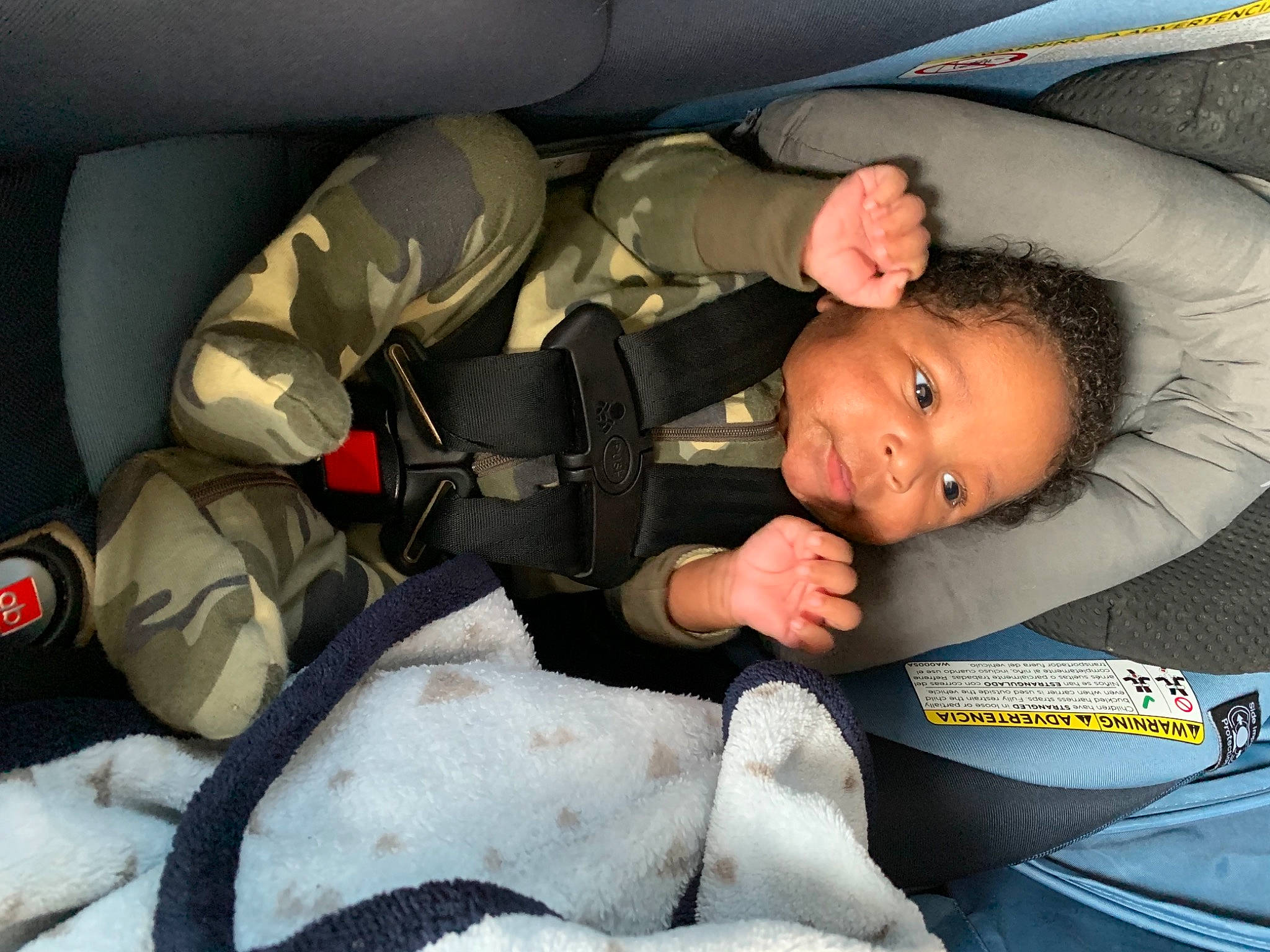 King is registered to the contest to win money with this photo: auto_part, automotive_design, automotive_exterior, baby, baby_carriage, baby_in_car_seat, baby_products, car_seat, car_seat_cover, child, comfort, face, head_restraint, human_body, leg, motor_vehicle, person, seat_belt, toddler, vehicle_door