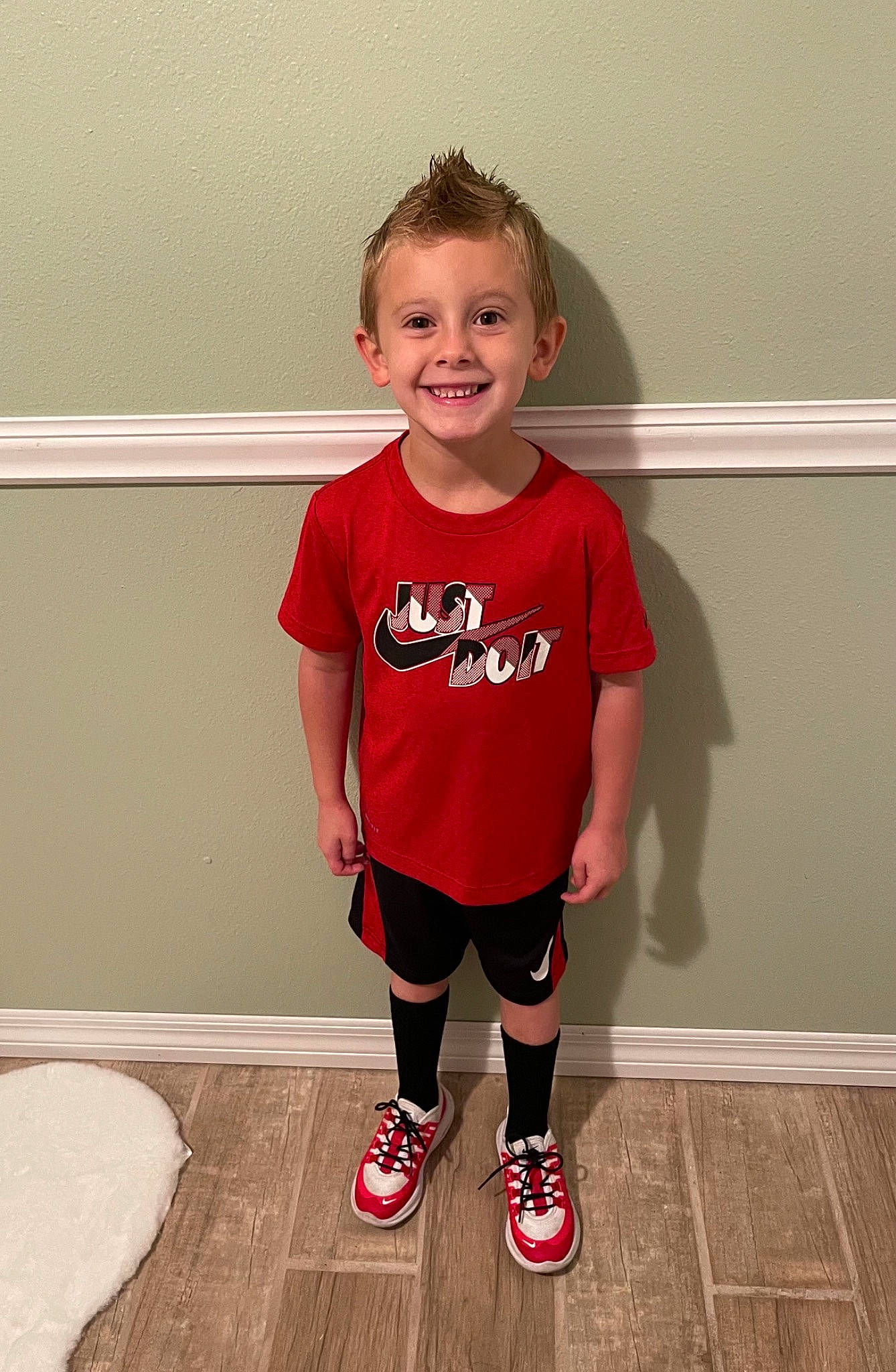 Bensen is registered to the contest to win money with this photo: baby_toddler_clothing, cool, face, floor, flooring, happy, head, human_body, joint, joy, knee, leg, neck, outerwear, person, shorts, shoulder, sleeve, smile, sportswear