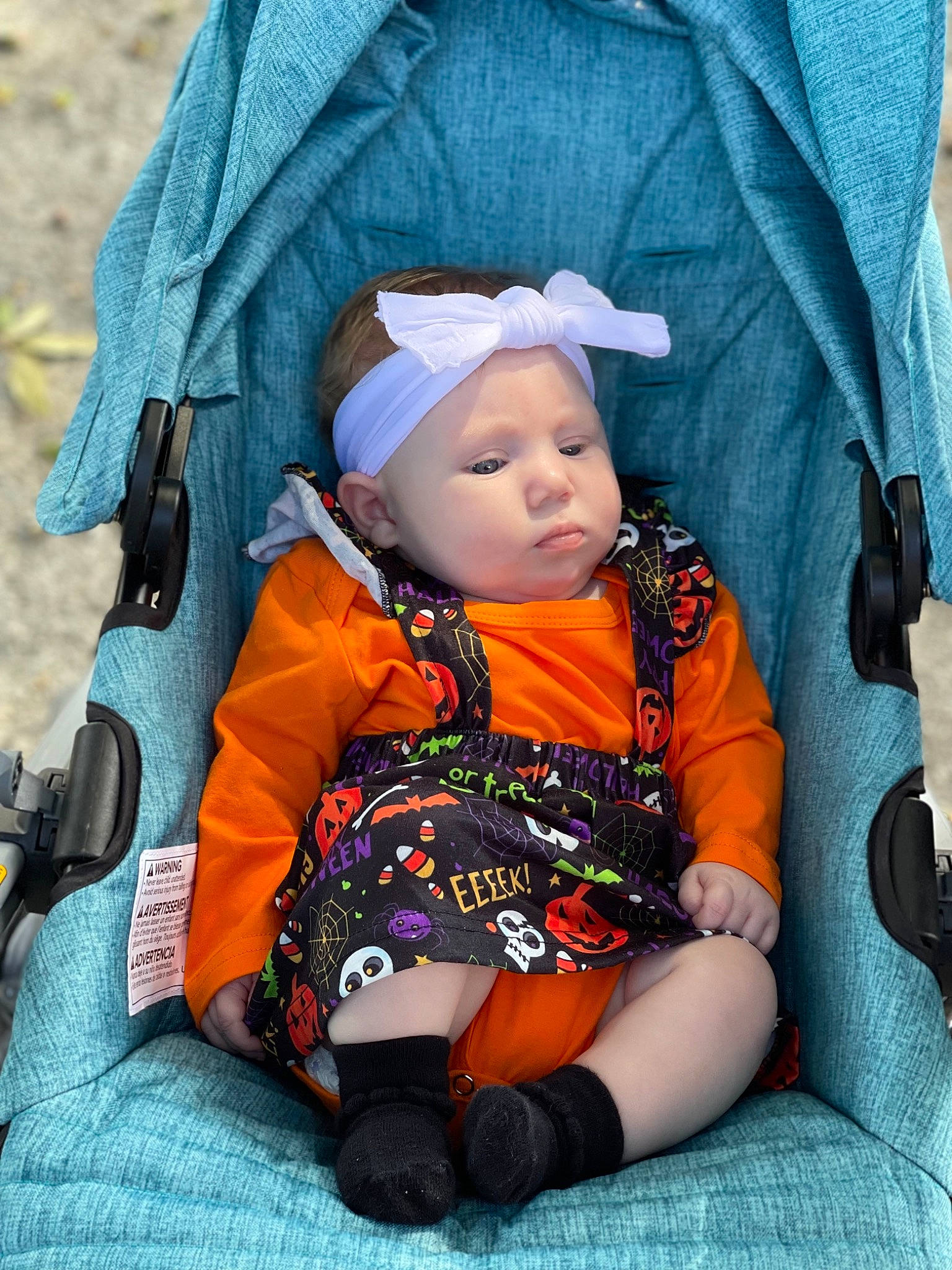 Everly Rose is registered to the contest to win money with this photo: baby, baby_carriage, baby_products, baby_safety, baby_toddler_clothing, car_seat, child, comfort, electric_blue, eye, fashion_accessory, fun, grass, hat, headwear, human_body, lap, orange, person, sitting
