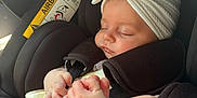 Novah-Seren is registered to the contest to win money with this photo: baby, sleeping, car_seat, headband, white_headband, bow, hand, holding, infant, child, seatbelt, black, closeup, peaceful, resting, human, skin, cute, toddler, transportation