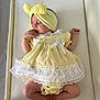 Novah-Seren is registered to the contest to win money with this photo: baby, sleeping, infant, yellow_dress, headband, white_lace, soft_surface, peaceful, cute, newborn, wrapped, small_hands, small_feet, toddler, child, indoors, portrait, adorable, resting, clothing
