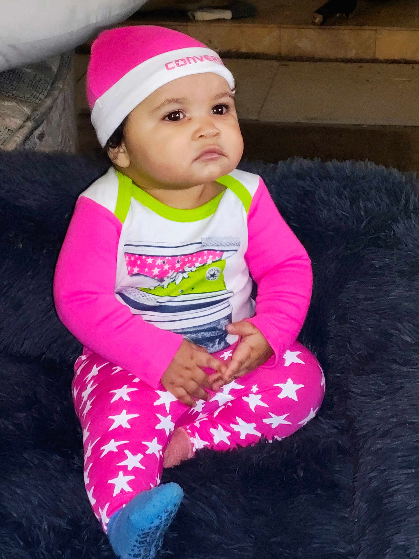 Jada joined the competition — help win amazing prizes! baby, child, pink_hat, pink_pants, stars_pattern, socks, cushion, indoor, portrait, serious_expression, clothing, sitting, floor, cute, person, young_child, fashion, cozy, headwear, footwear