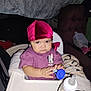Jada is registered to the contest to win money with this photo: baby, child, high_chair, bottle, milk, head_wrap, purple_shirt, minnie_mouse, face, hands, indoor, blanket, toy, curious, expression, seated, feeding, person, infant, closeup