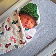 Michael is registered to the contest to win money with this photo: newborn, baby, sleeping, blanket, footprint_pattern, knit_hat, green_hat, crib, bedding, infant, resting, cozy, soft, portrait, child, wrapped, peaceful, indoors, cute, toddler