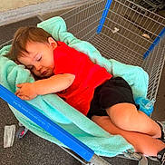 Wyatt joined the competition — help win amazing prizes! toddler, child, sleeping, shopping_cart, blanket, red_shirt, black_shorts, blue_sippy_cup, indoors, floor, person, cute, resting, cozy, clothing, head, footwear, toy, relaxation, shopping